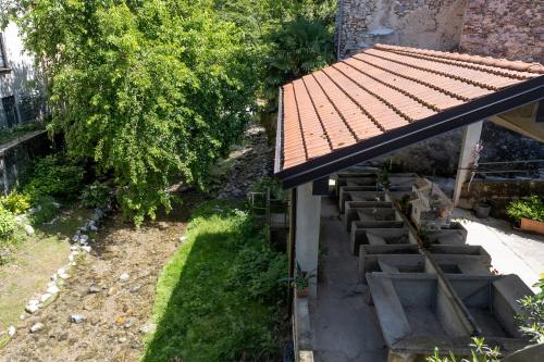 a view of a building with a roof and steps at La casa sotto le cascate Lago Maggiore - IXIHOME in Cittiglio