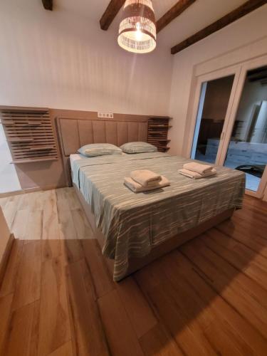 a bedroom with a bed with two towels on it at Villa Bosna Near Dubrovnik very beautiful Villa entirely privatized swimming pool, jacuzzi, sauna, billiard, ping-pong in Ivanica