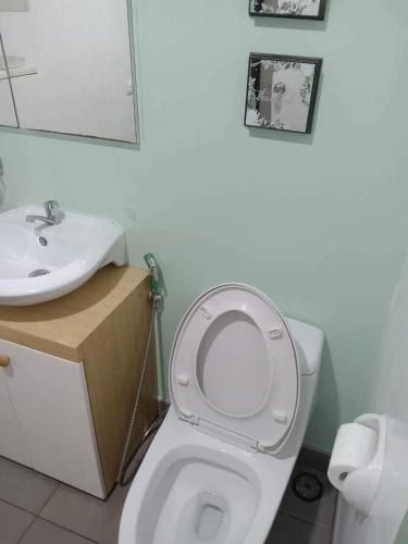 a bathroom with a white toilet and a sink at 1 BR Centrio Tower 926 in Cagayan de Oro