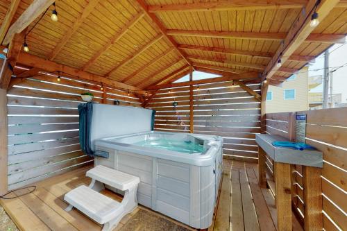 a sauna with a soaking tub in a wooden room at Grand Pacific in Rockaway Beach