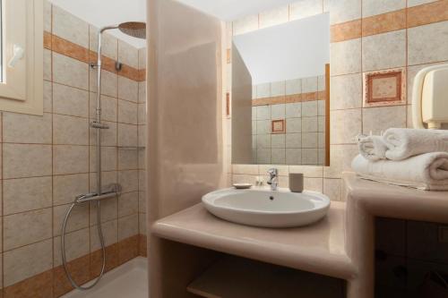 a bathroom with a sink and a shower at Almar Apartments in Batsi