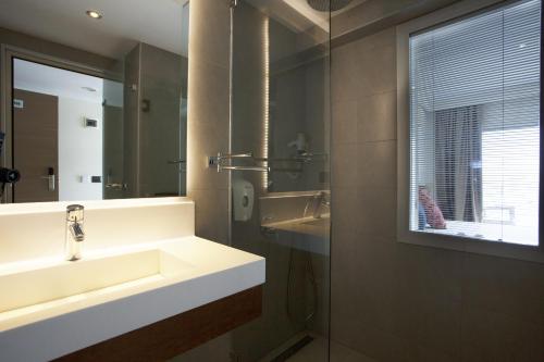 a bathroom with a sink and a mirror at KUMBAHÇE GULET Hotel in Bodrum City