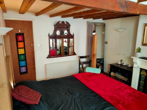 a bedroom with a large bed with a red blanket at Central Nottingham Studio in Nottingham
