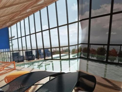 a view of a swimming pool through a large window at Wanderlust Experience Hotel in Campos do Jordão