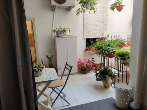 a room with a table and chairs and potted plants at essential in Palermo