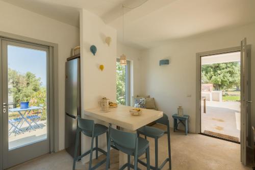 a kitchen with a table and chairs and a dining room at New Villa Filara with Sea view Pool in Specchiolla 