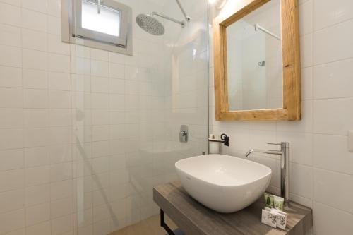 a white bathroom with a sink and a mirror at New Villa Filara with Sea view Pool in Specchiolla 