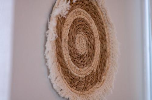 a brown and white rug hanging on a wall at Chora Suite in Alonnisos
