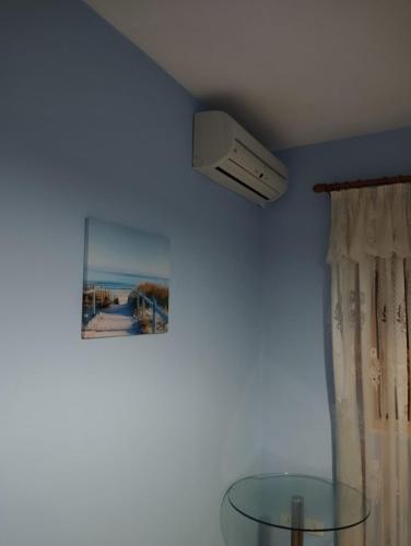 a room with a ceiling fan and a glass table at ARIA Apartament in Durrës