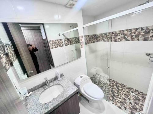 a person taking a picture of a bathroom at 2403 Apto privado con vista en el centro de B/ga in Bucaramanga