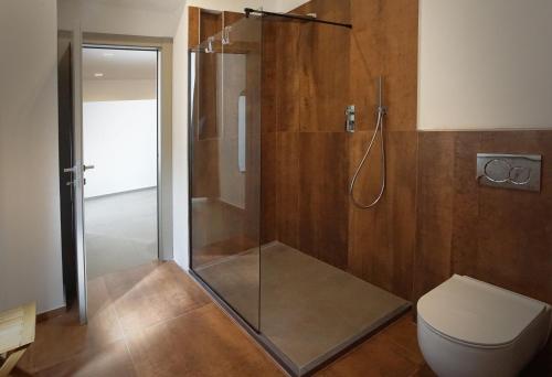 a bathroom with a shower and a toilet at New Moon Rooms in La Spezia