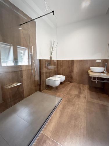 a bathroom with a shower and a toilet and a sink at New Moon Rooms in La Spezia