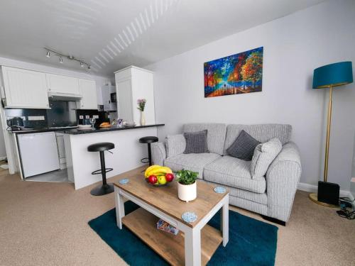 a living room with a couch and a table at Dove Apartments in Oxford