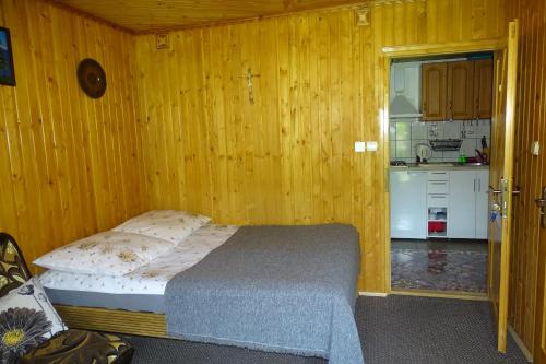 1 dormitorio con 1 cama en una habitación de madera en U lisa en Zakopane