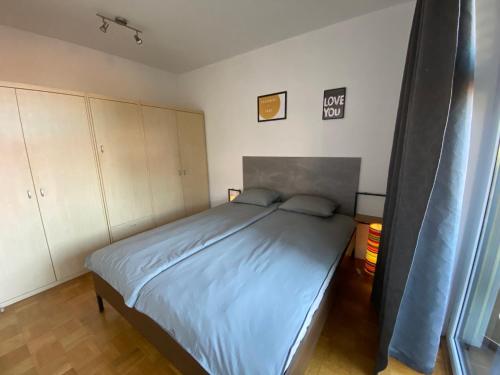 a bedroom with a large bed with blue sheets at Apartma Felicija in Ljubljana