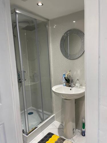 a bathroom with a shower and a sink at One Bedroom Self Catered Serviced Accommodation 10 Minutes from City Center in Edinburgh