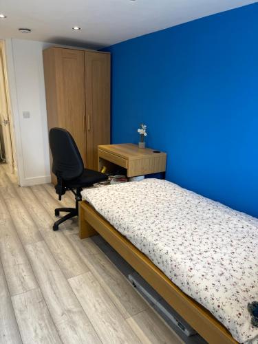 a bedroom with a bed and a desk and a chair at One Bedroom Self Catered Serviced Accommodation 10 Minutes from City Center in Edinburgh