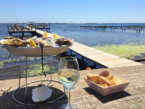 a table with a basket of bread and a glass of wine at Maison avec extérieur proche saint Guilhem le desert in Saint-André-de-Sangonis