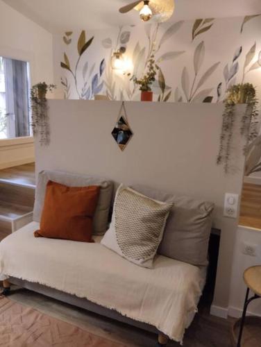 a couch with pillows on it in a living room at Les salenques in Toulouse