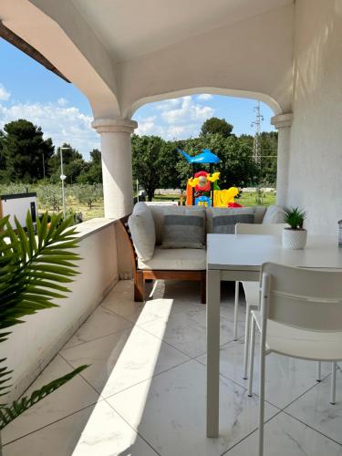 a patio with a couch and a table with a clown in the background at VOLMEfamily in Pula