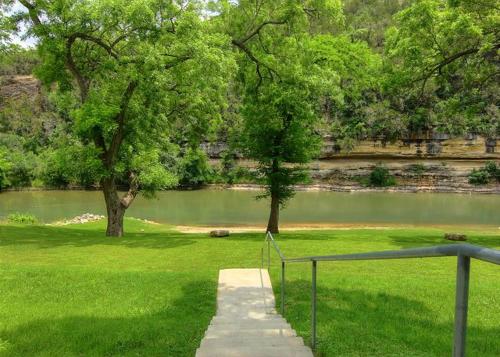 a path in a park with a pond and trees at RG 111 Guadalupe Fortress of Awesome in Canyon Lake