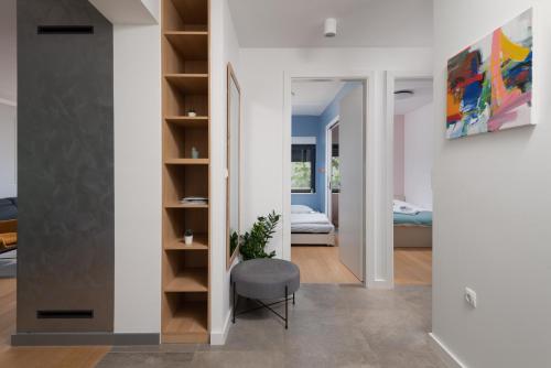 a room with a chair and a room with a bedroom at Villa Voyage in Zadar