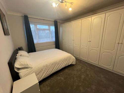 a small bedroom with a bed and a window at Gants hill in Barkingside