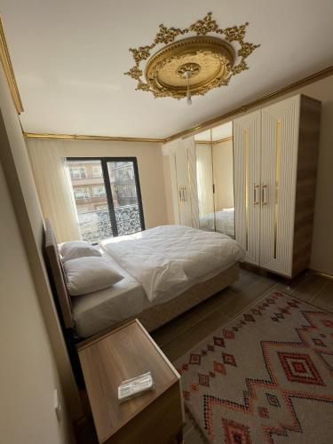 a bedroom with a bed and a chandelier at Yılmaz Bey Konağı in Termal