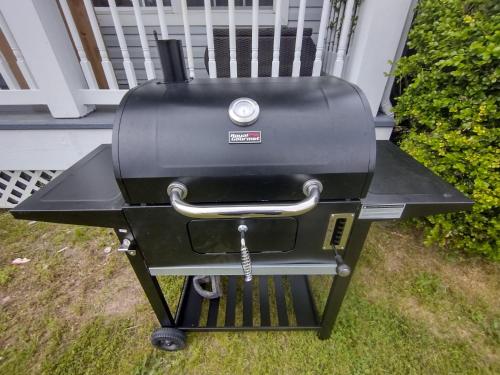 a grill sitting on the grass in front of a house at AMAZING!!!! Luxury 5BR, Steps to beach and Fun! Fully Renovated Beach house! in Atlantic City