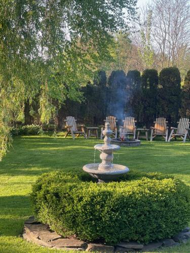 a fountain in the middle of a park with chairs at Williston Village Inn in Burlington