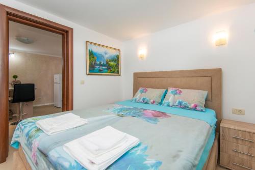 sypialnia z łóżkiem z ręcznikami w obiekcie Hillside Seaview Apartment w Kotorze