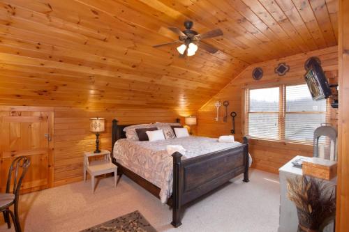 a bedroom with a bed in a log cabin at Sweet Retreat in Boone