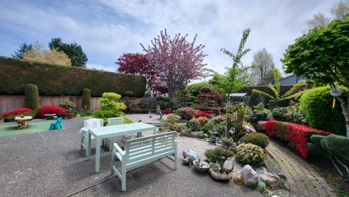 a garden with a blue bench and many plants at sweet home in Richmond