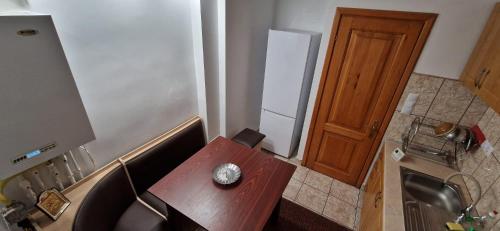 a small kitchen with a wooden table and a sink at ANASTASIA. in Tulcea