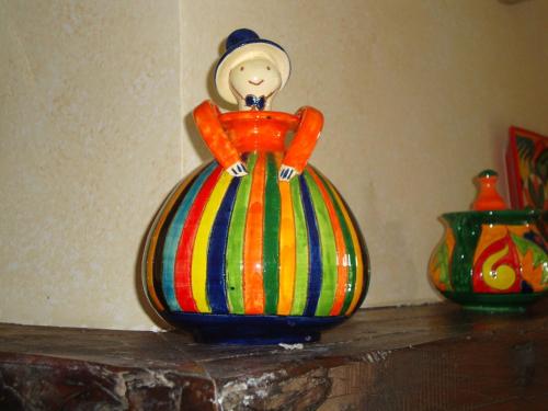 a colorful vase sitting on a shelf next to two vases at Hotel Pikassaria in Sare