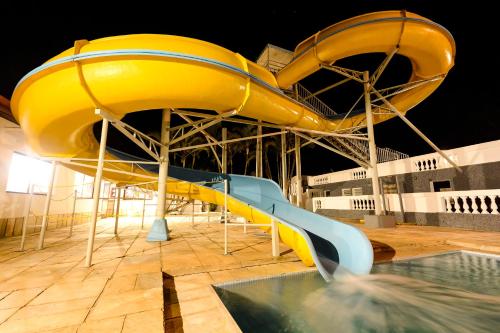 a pool with a slide on a cruise ship at Hotel Fazenda Aguas de Lindoia in Águas de Lindóia