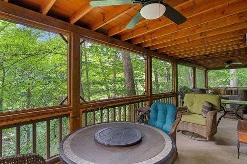 a screened in porch with a table and chairs at Nana's Nest in Blue Ridge