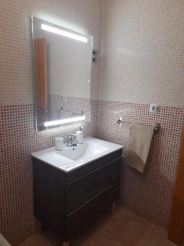 a bathroom with a sink and a mirror at Piso Serena beach in Águilas