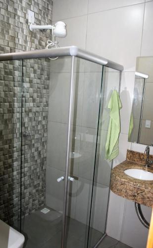 a bathroom with a shower and a sink at Residencial Lucernaré - Tiririca in Itacaré