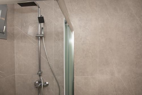 a shower with a glass door in a bathroom at Suite of Liberty in Kos Town