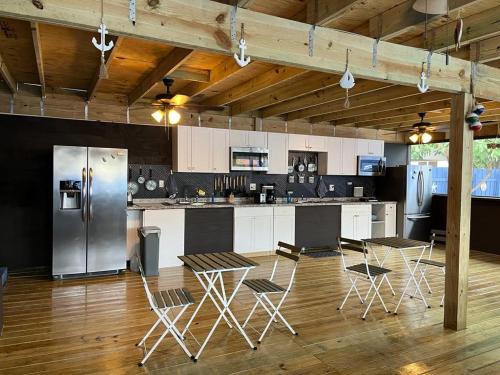 a kitchen with a refrigerator and tables and chairs at Blue Little Havana in Miami