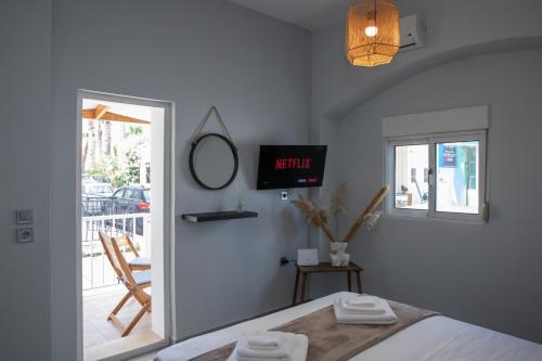 a bedroom with a bed and a view of a balcony at Suite of Liberty in Kos Town