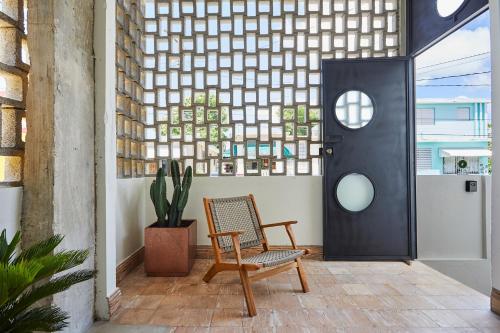 a chair in front of a door with a window at DADA JAJA by DW in San Juan