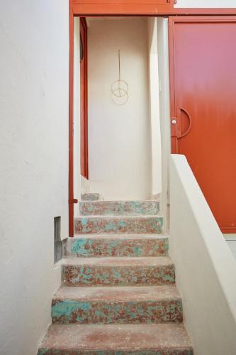 a set of stairs leading to a red door at DADA JAJA by DW in San Juan