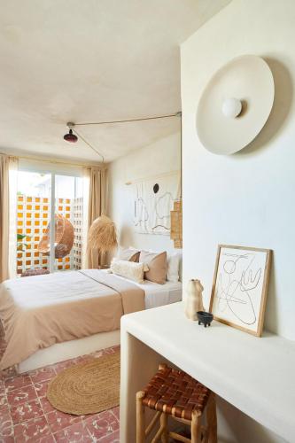a bedroom with two beds and a table with a mirror at DADA JAJA by DW in San Juan