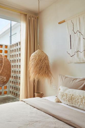a bedroom with a bed and a large window at DADA JAJA by DW in San Juan