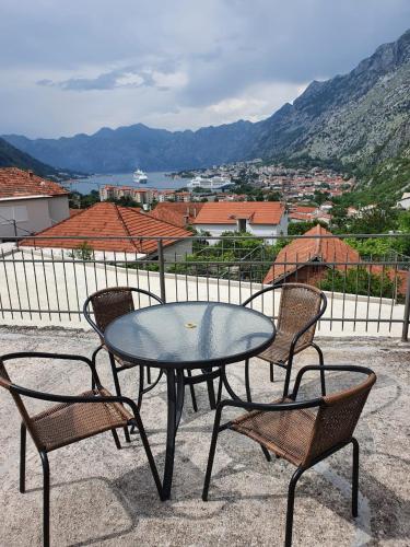 a table and chairs with a view of a city at Apartment Marta in Kotor