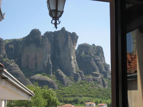 a view of a mountain from a window at Mythos Guesthouse in Kalabaka