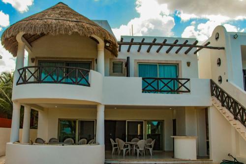 a large white house with a balcony and tables at Salamina Luxury private house in Uaymitun