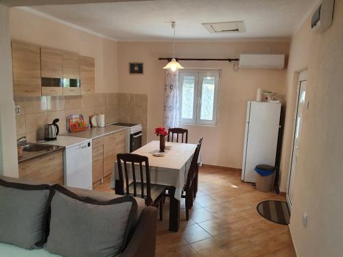 a kitchen and dining room with a table and a refrigerator at Apartment Marta in Kotor